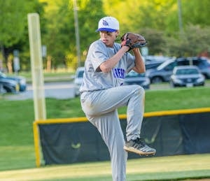 A young baseball player delivers a pitch during a game. Perfect for sports-related content.